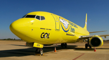 Avião da GOL amarelo e com o logotipo do Mercado Livre na lateral, em pouso