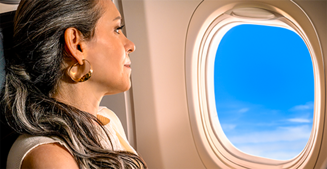 Cliente GOL viajando e olhando pela janela do avião
