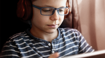 Boy looking at the tablet on the plane