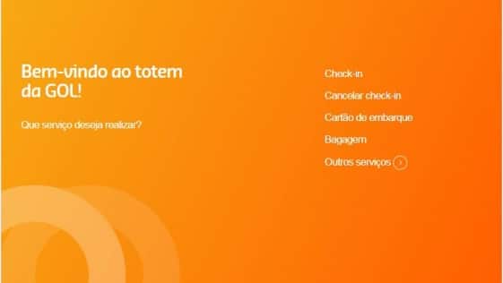 Imagem do painel mostrado no totem de autoatendimento, contendo as opções de linguagem Português, Inglês, Espanhol e Francês, ao lado direito há um botão de sair, logo abaixo há os dizeres no lado esquerdo da tela: "Bem-Vindo ao totem da GOL! Qual serviço deseja realizar?" com as seguintes opções a direita: Check-In, Cancelar Chek-In, Cartão de Embraque, Bagagem e outros serviços